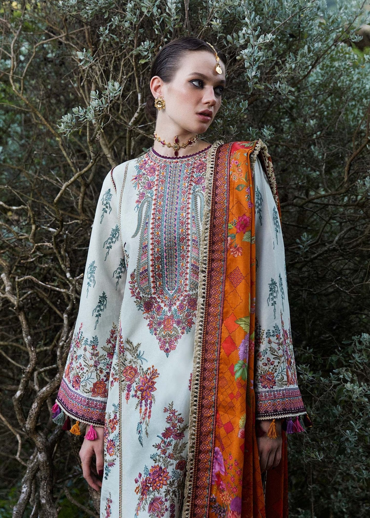 Model wearing a white Sumbul dress with colorful floral patterns from Hussain Rehar's Zaiba Lawn '24 collection. Pakistani clothes online in UK.