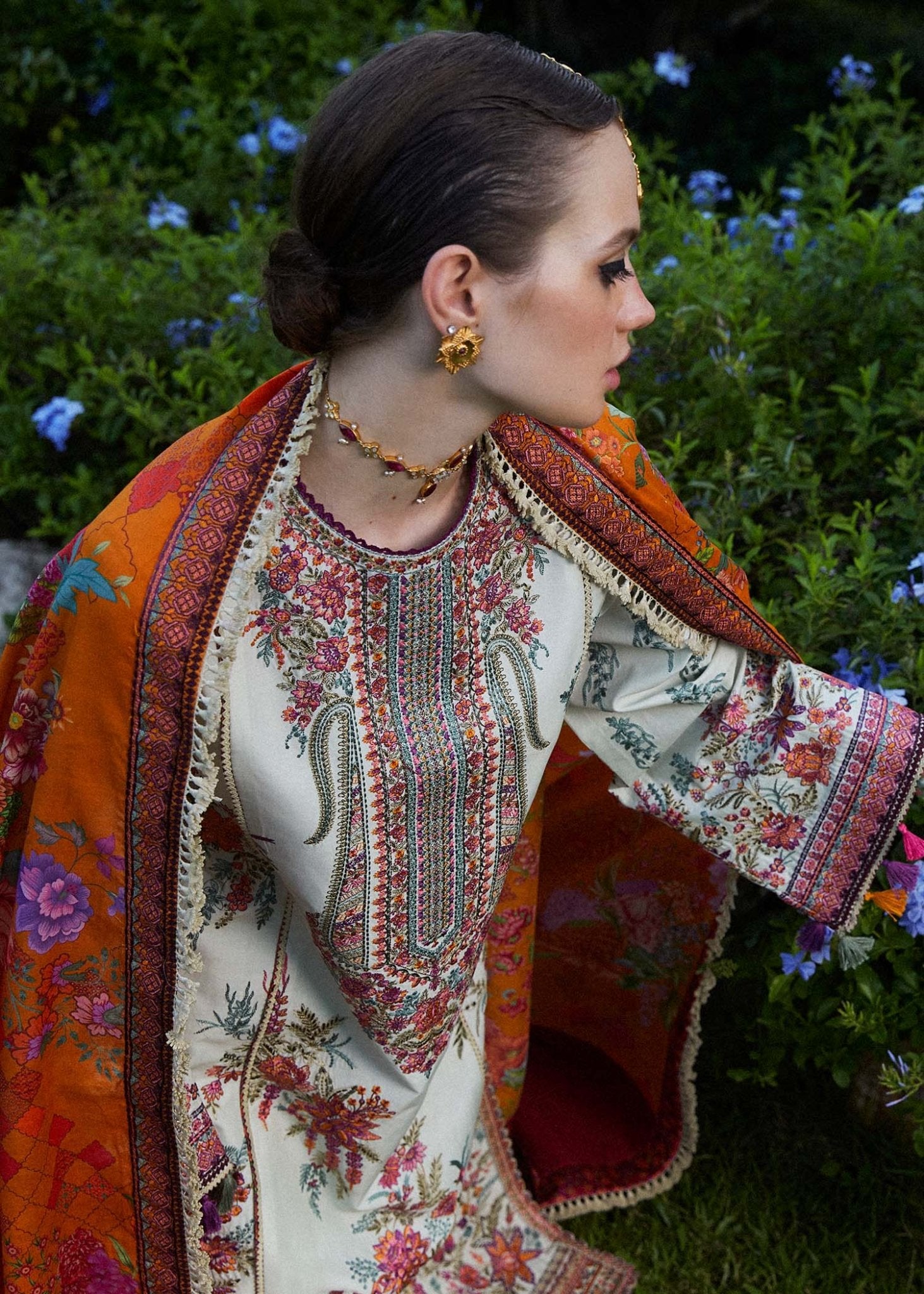 Model wearing a white Sumbul dress with colorful floral patterns from Hussain Rehar's Zaiba Lawn '24 collection. Pakistani clothes online in UK.