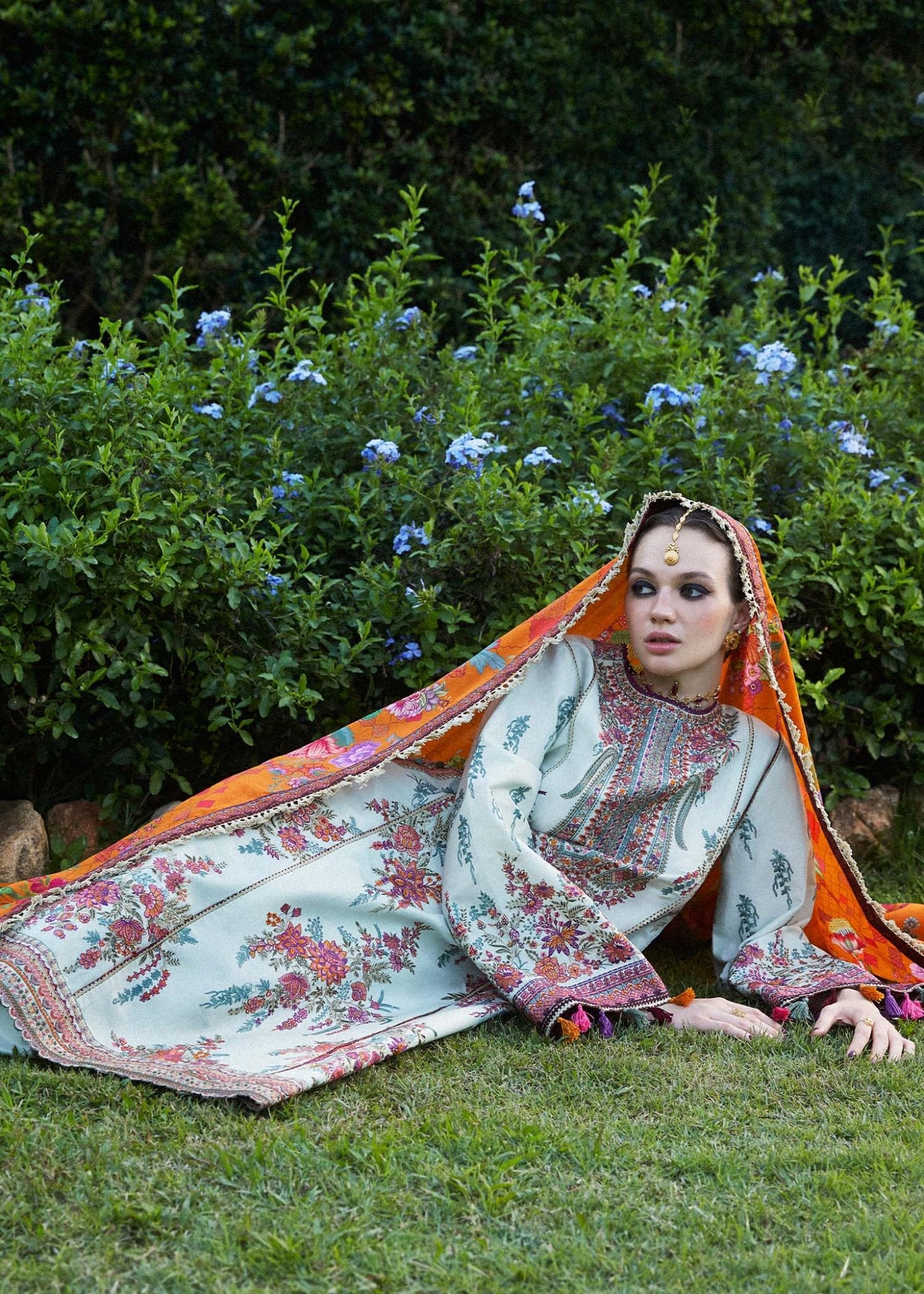 Model wearing a white Sumbul dress with colorful floral patterns from Hussain Rehar's Zaiba Lawn '24 collection. Pakistani clothes online in UK.