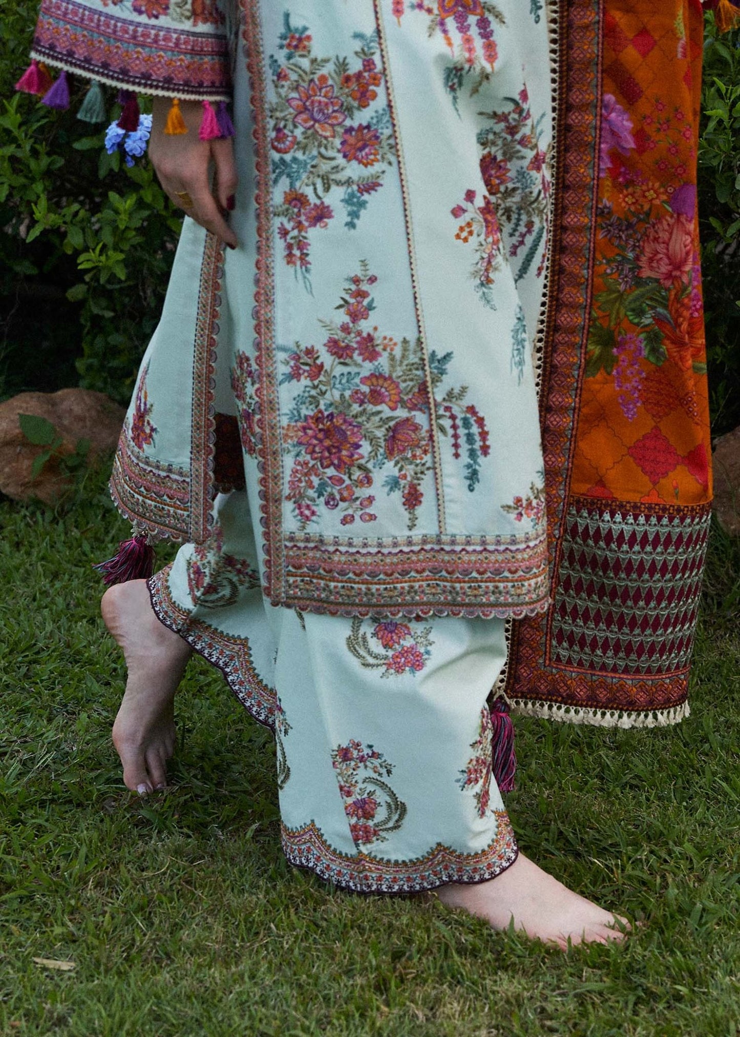 Model wearing a white Sumbul dress with colorful floral patterns from Hussain Rehar's Zaiba Lawn '24 collection. Pakistani clothes online in UK.