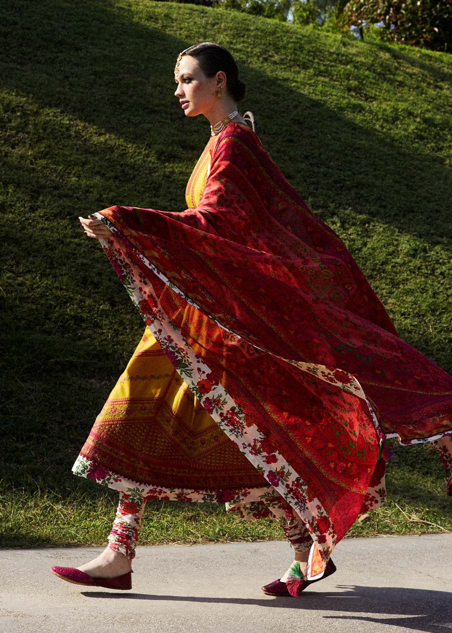 Model wearing a yellow Sunehri dress from Hussain Rehar's Zaiba Lawn '24 collection. Pakistani clothes online in UK. Vibrant floral patterns.