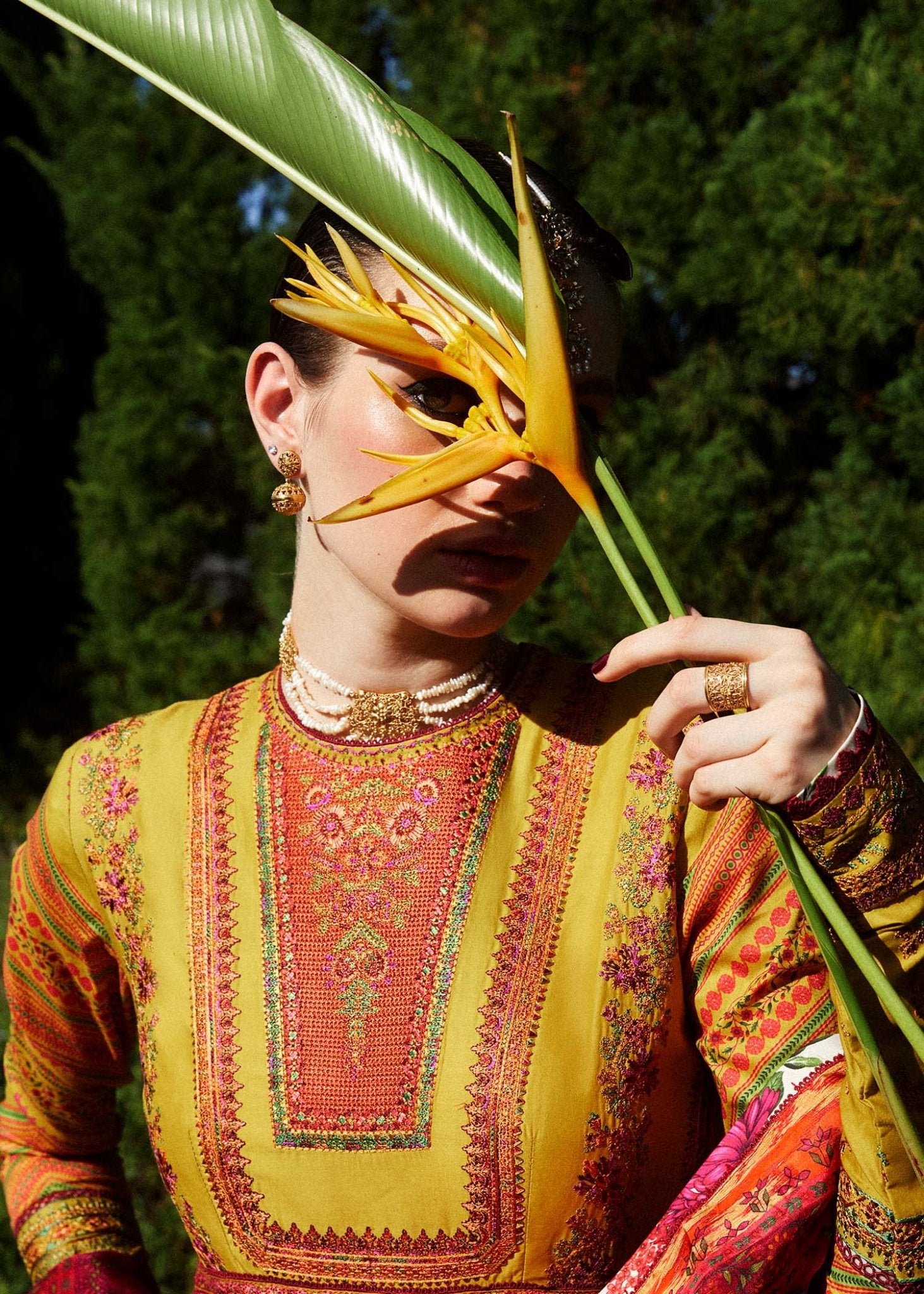 Model wearing a yellow Sunehri dress from Hussain Rehar's Zaiba Lawn '24 collection. Pakistani clothes online in UK. Vibrant floral patterns.