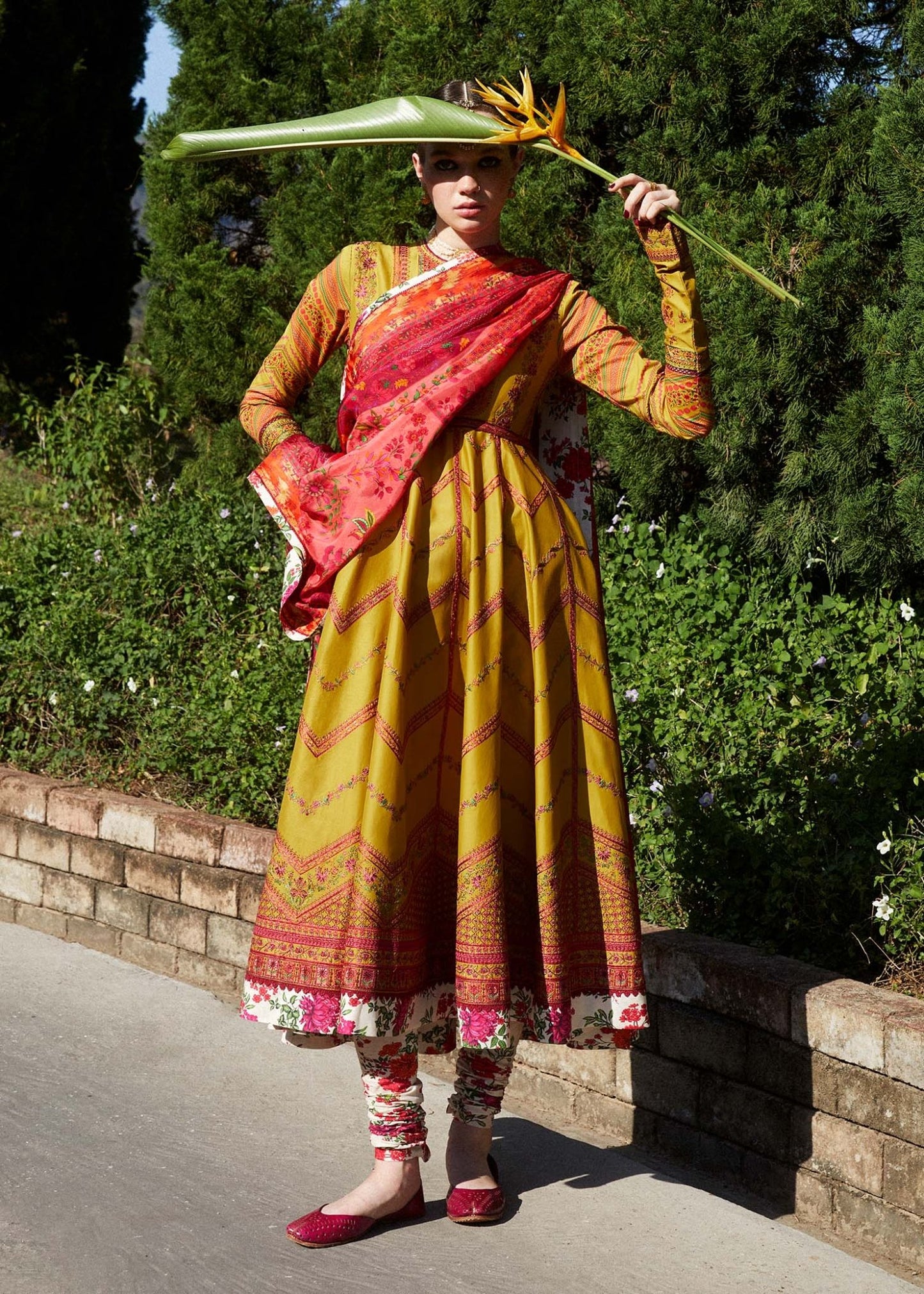 Model wearing a yellow Sunehri dress from Hussain Rehar's Zaiba Lawn '24 collection. Pakistani clothes online in UK. Vibrant floral patterns.