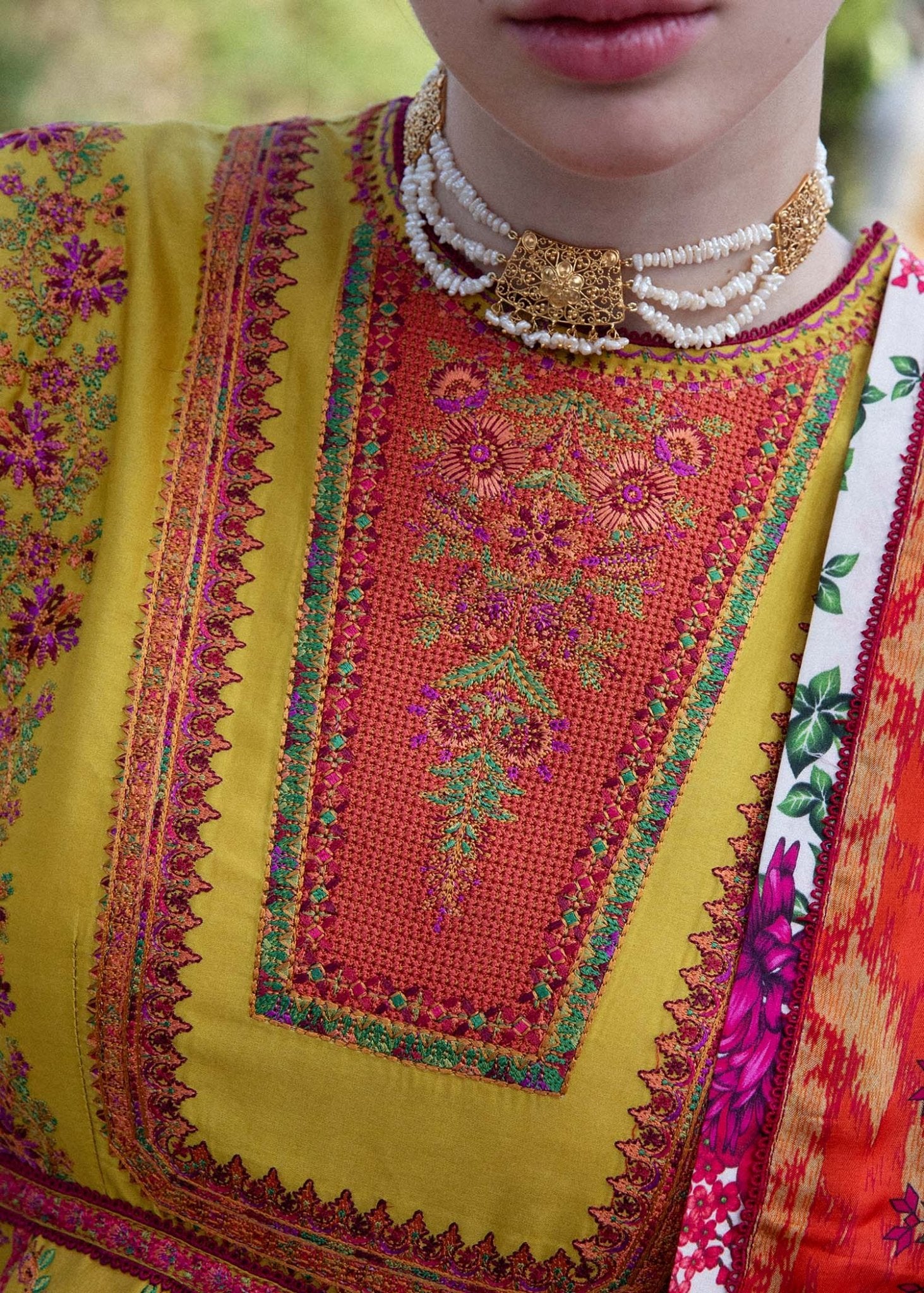 Model wearing a yellow Sunehri dress from Hussain Rehar's Zaiba Lawn '24 collection. Pakistani clothes online in UK. Vibrant floral patterns.