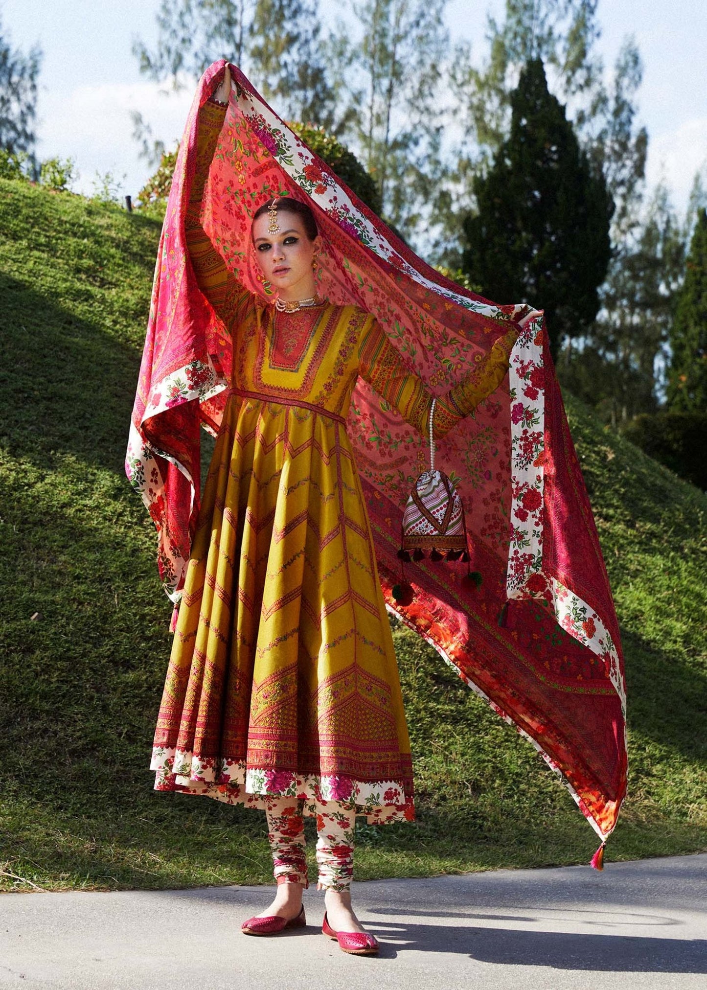 Model wearing a yellow Sunehri dress from Hussain Rehar's Zaiba Lawn '24 collection. Pakistani clothes online in UK. Vibrant floral patterns.