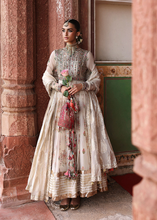 Model wearing Zayrah by Hussain Rehar in ivory and gold with intricate embroidery – regal Pakistani luxury pret outfit in UK.