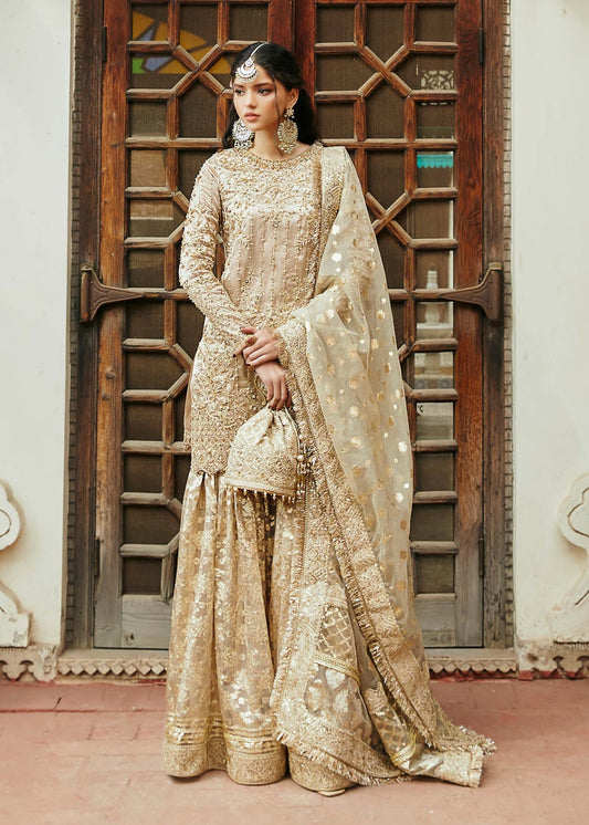 Model wearing gold Chaman dress from Kanwal Malik, Afsheen Luxury Pret 2024 collection. Pakistani clothes online in UK, wedding clothes.