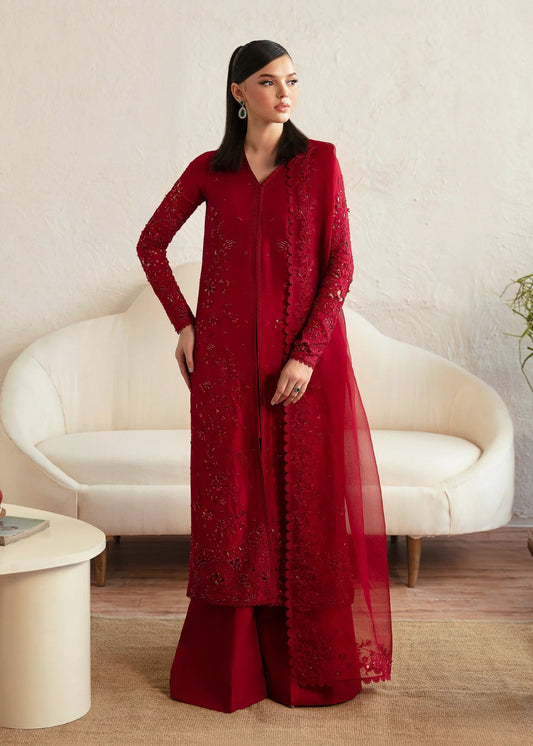 Model wearing a red Aleysa dress from Kanwal Malik. Elegant Pakistani wedding clothes available online in the UK. Perfect for luxury events and celebrations.