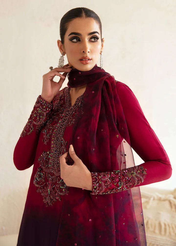 Model wearing a maroon and deep purple Aroha dress from Kanwal Malik's Amelie Luxury Pret collection. Ideal for wedding clothes and Pakistani clothes online in the UK.