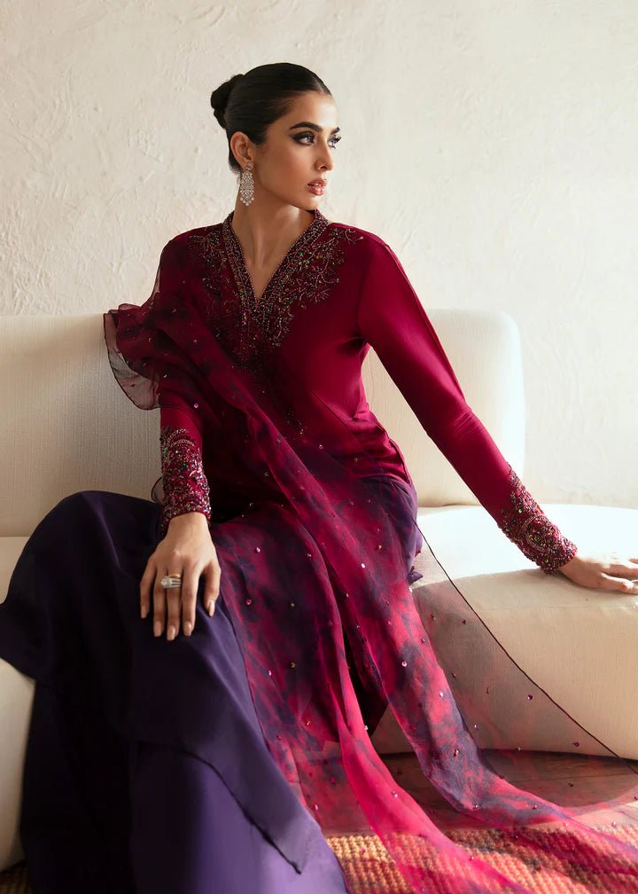 Model wearing a maroon and deep purple Aroha dress from Kanwal Malik's Amelie Luxury Pret collection. Ideal for wedding clothes and Pakistani clothes online in the UK.