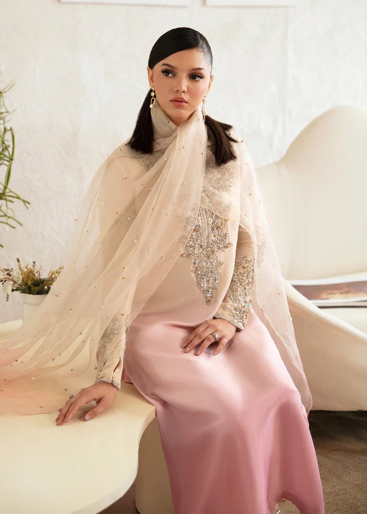 Model wearing a Kanwal Malik Maura dress in soft pink and cream gradient. Highlighting intricate embroidery, ideal for Pakistani wedding clothes online in the UK.