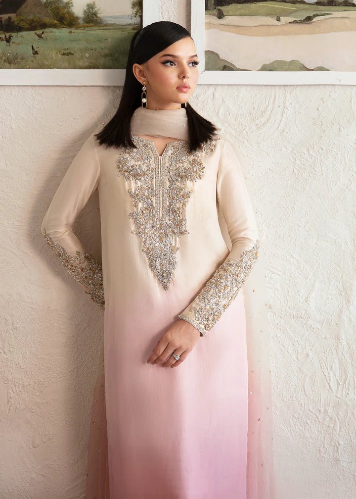 Model wearing a Kanwal Malik Maura dress in soft pink and cream gradient. Highlighting intricate embroidery, ideal for Pakistani wedding clothes online in the UK.