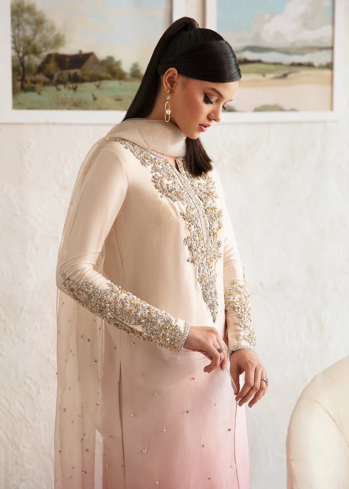 Model wearing a Kanwal Malik Maura dress in soft pink and cream gradient. Highlighting intricate embroidery, ideal for Pakistani wedding clothes online in the UK.