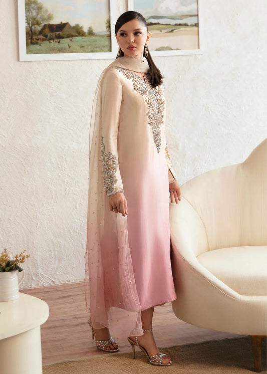 Model wearing a Kanwal Malik Maura dress in soft pink and cream gradient. Highlighting intricate embroidery, ideal for Pakistani wedding clothes online in the UK.