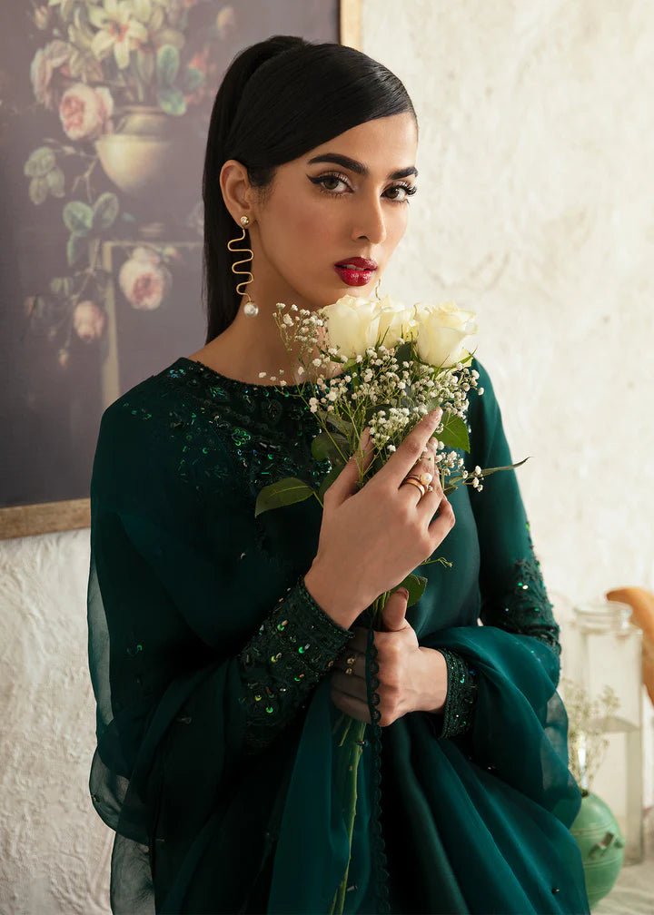 Model wearing an elegant dark green dress with intricate embroidery from Kanwal Malik's Amelie Luxury Pret collection. Perfect for weddings, Pakistani clothes online in UK.