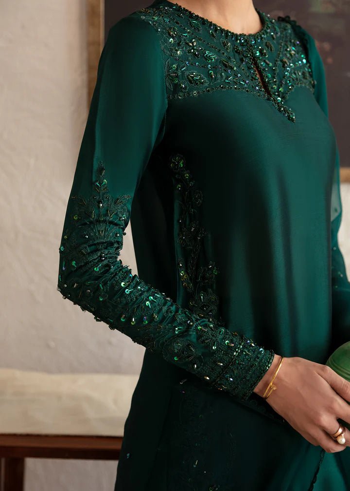 Model wearing an elegant dark green dress with intricate embroidery from Kanwal Malik's Amelie Luxury Pret collection. Perfect for weddings, Pakistani clothes online in UK.