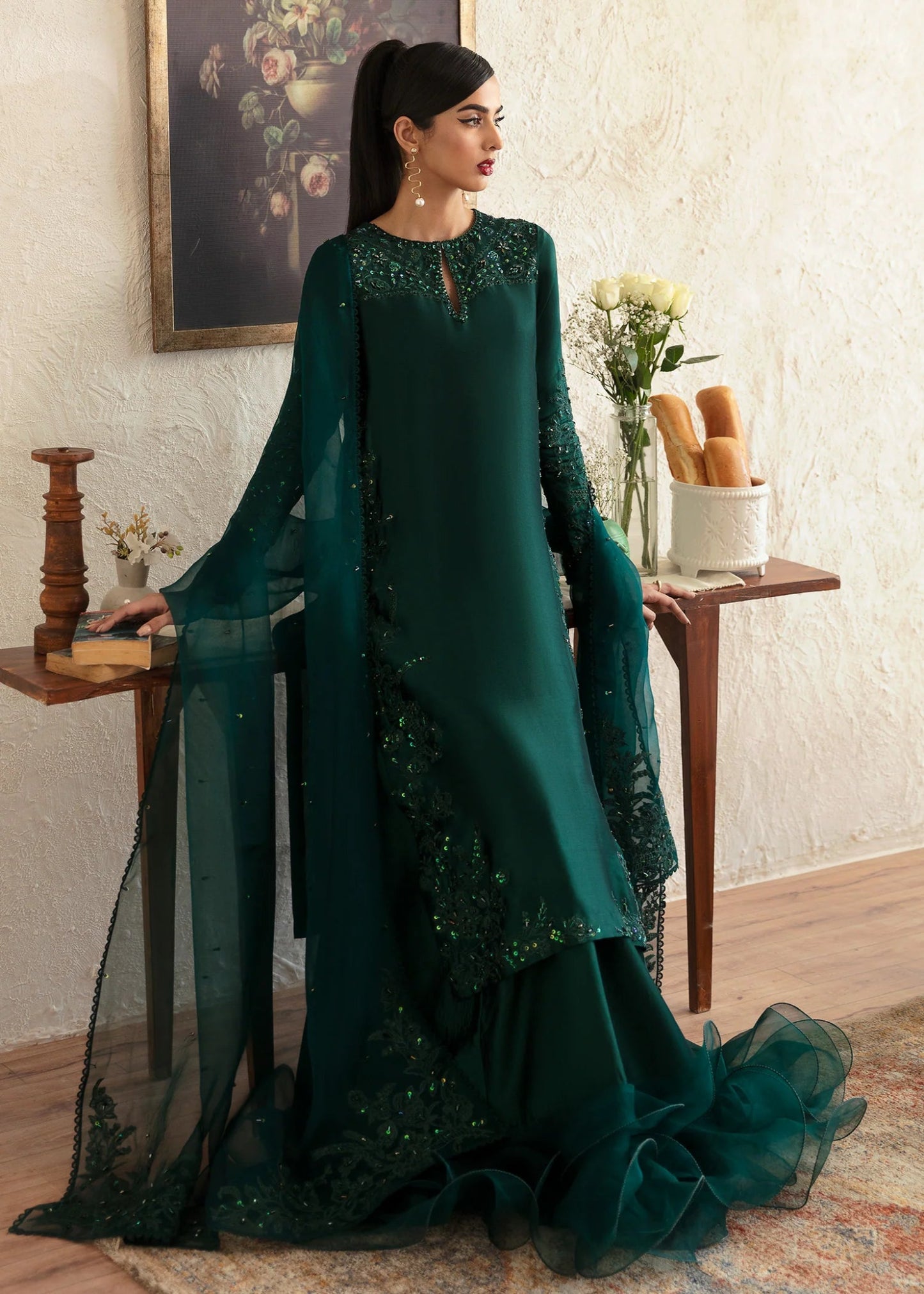 Model wearing an elegant dark green dress with intricate embroidery from Kanwal Malik's Amelie Luxury Pret collection. Perfect for weddings, Pakistani clothes online in UK.