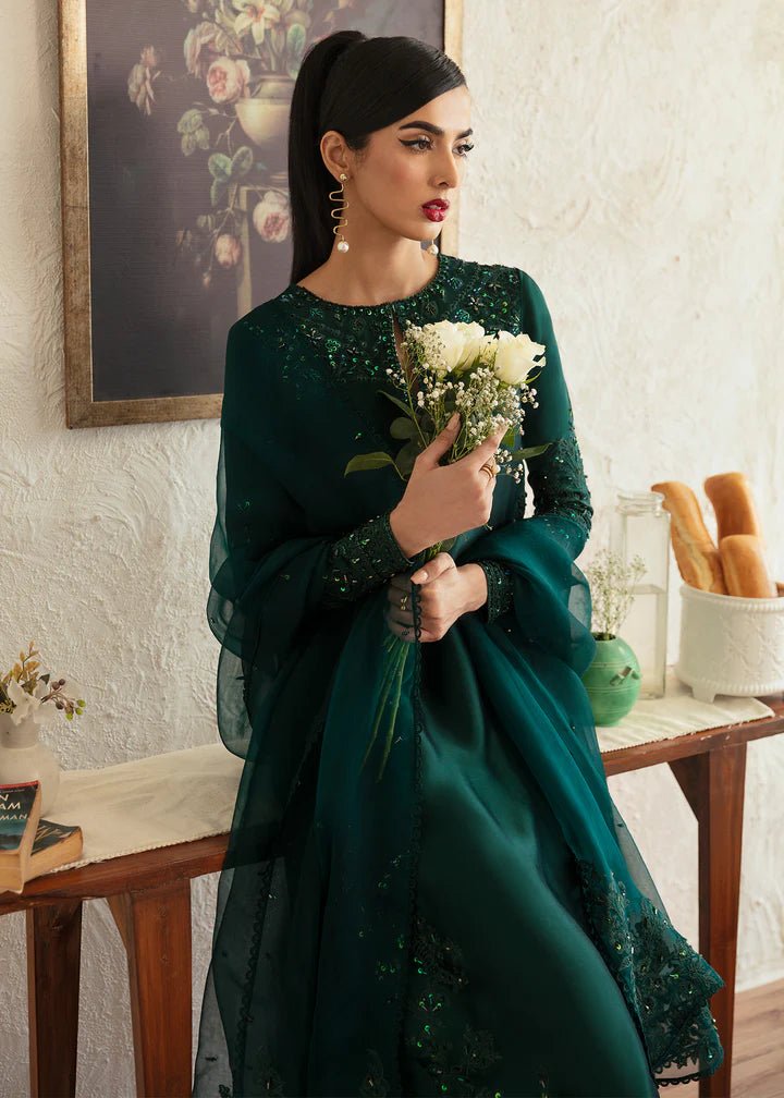 Model wearing an elegant dark green dress with intricate embroidery from Kanwal Malik's Amelie Luxury Pret collection. Perfect for weddings, Pakistani clothes online in UK.