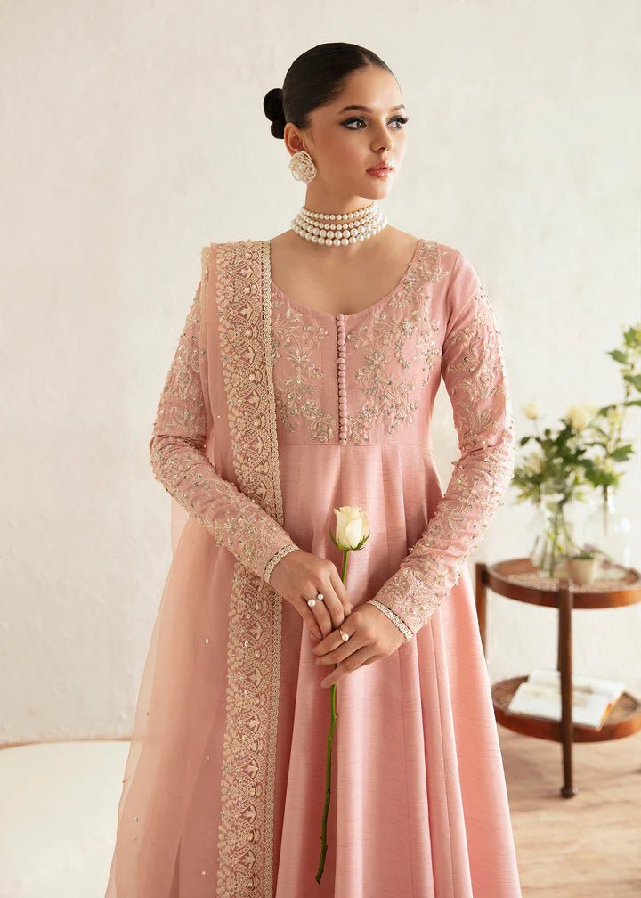 Model wearing a pastel pink dress with intricate embroidery from Kanwal Malik's Amelie Luxury Pret collection. Highlighting Pakistani clothes online in the UK, perfect for weddings.