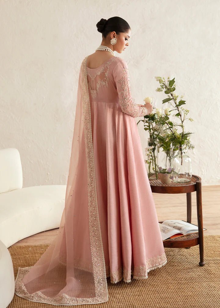 Model wearing a pastel pink dress with intricate embroidery from Kanwal Malik's Amelie Luxury Pret collection. Highlighting Pakistani clothes online in the UK, perfect for weddings.