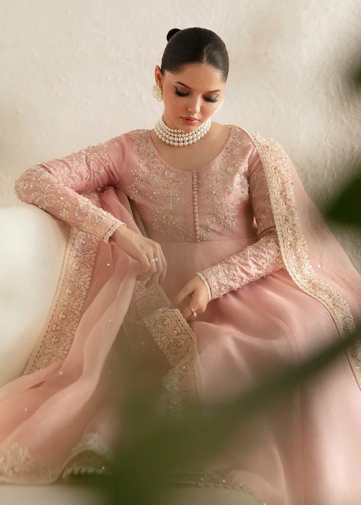 Model wearing a pastel pink dress with intricate embroidery from Kanwal Malik's Amelie Luxury Pret collection. Highlighting Pakistani clothes online in the UK, perfect for weddings.