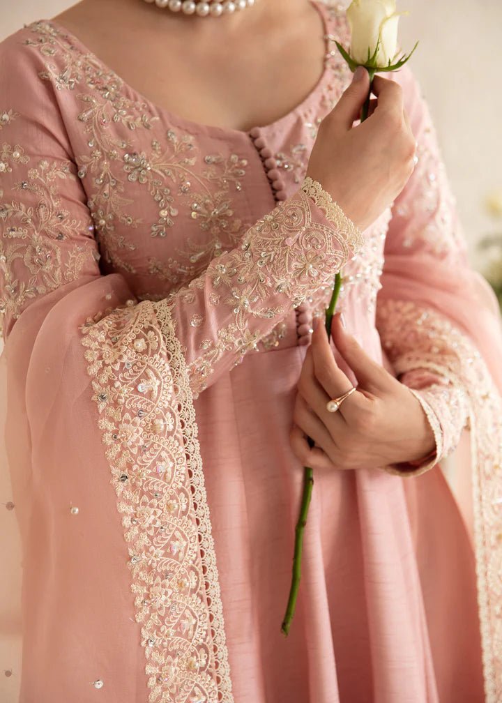 Model wearing a pastel pink dress with intricate embroidery from Kanwal Malik's Amelie Luxury Pret collection. Highlighting Pakistani clothes online in the UK, perfect for weddings.