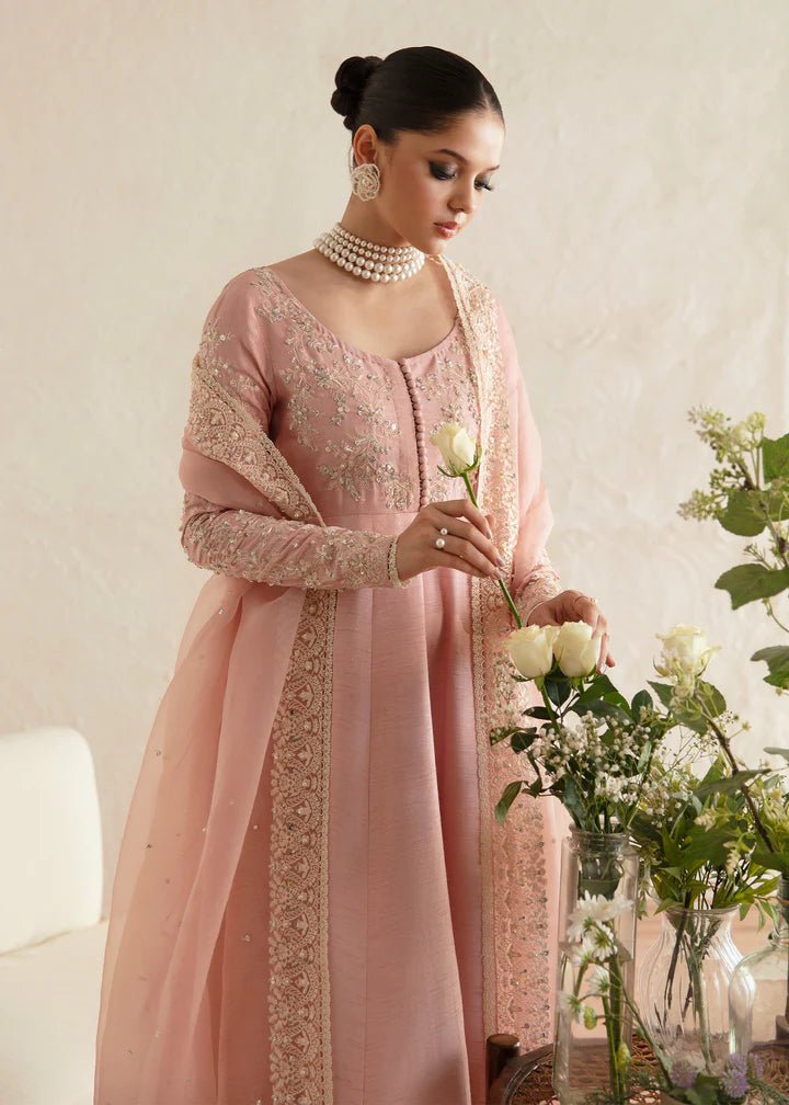 Model wearing a pastel pink dress with intricate embroidery from Kanwal Malik's Amelie Luxury Pret collection. Highlighting Pakistani clothes online in the UK, perfect for weddings.