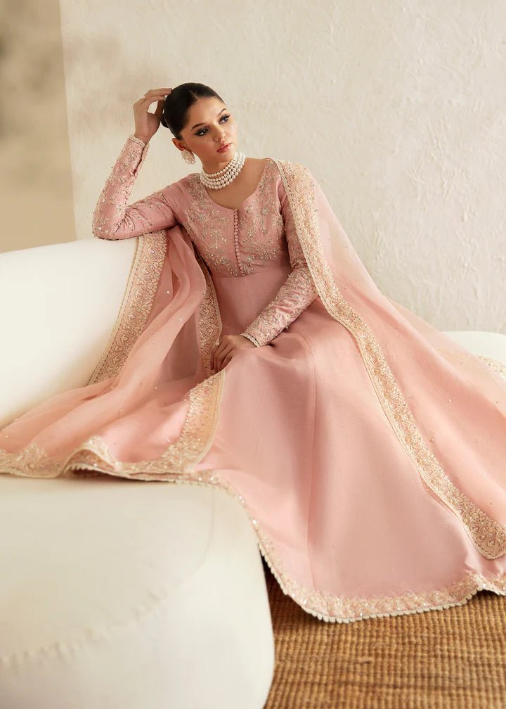 Model wearing a pastel pink dress with intricate embroidery from Kanwal Malik's Amelie Luxury Pret collection. Highlighting Pakistani clothes online in the UK, perfect for weddings.