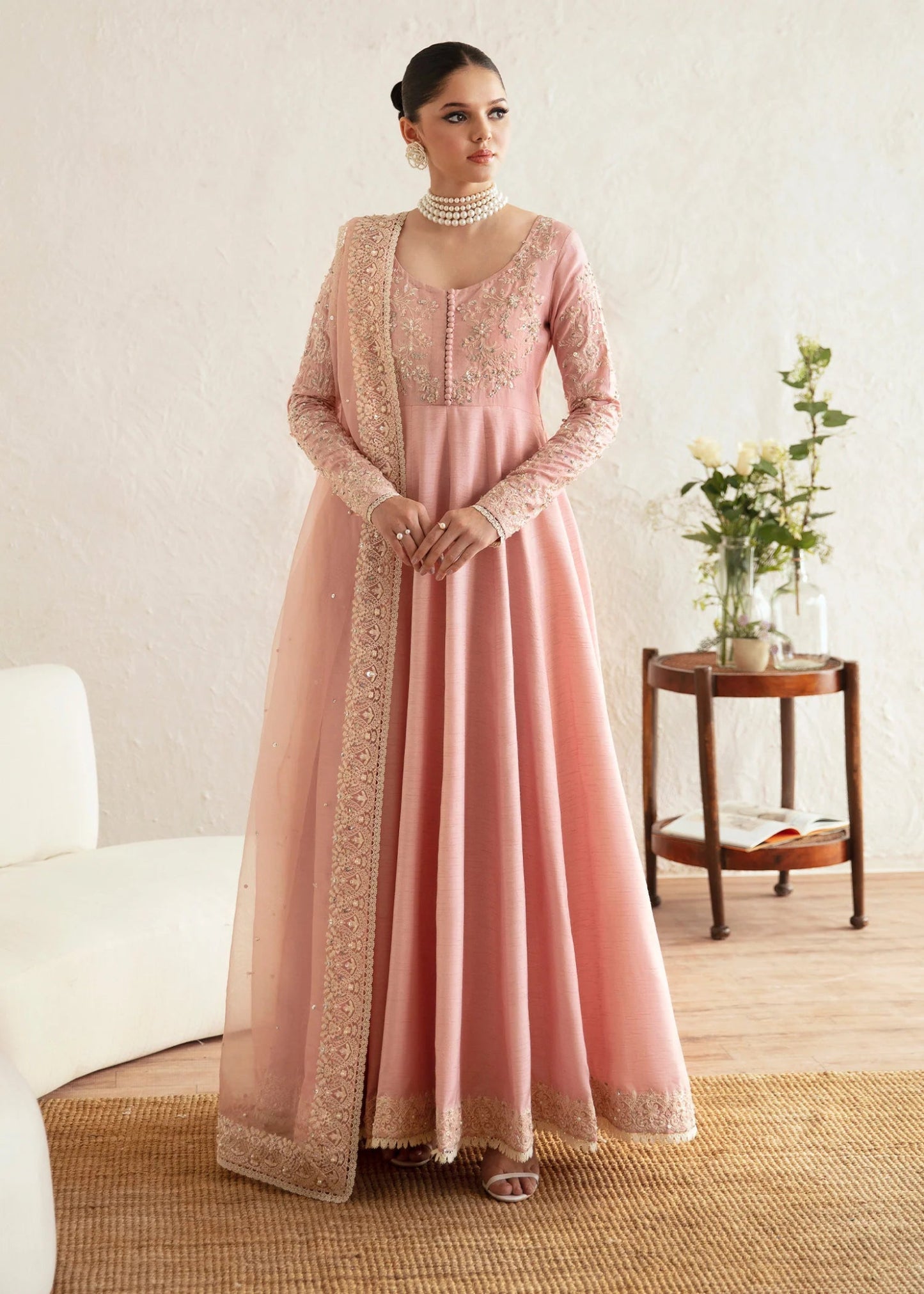 Model wearing a pastel pink dress with intricate embroidery from Kanwal Malik's Amelie Luxury Pret collection. Highlighting Pakistani clothes online in the UK, perfect for weddings.