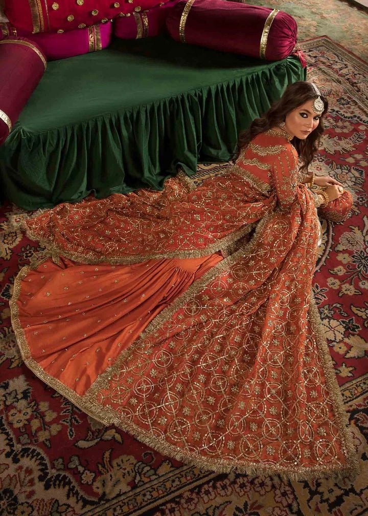 Model showcasing Kanwal Malik Angana '23 Narangi dress, representing Pakistani wedding attire online in the UK.