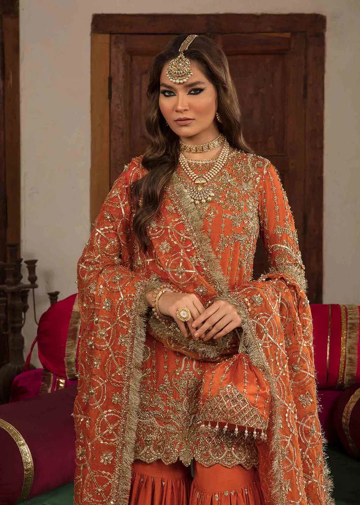 Model showcasing Kanwal Malik Angana '23 Narangi dress, representing Pakistani wedding attire online in the UK.