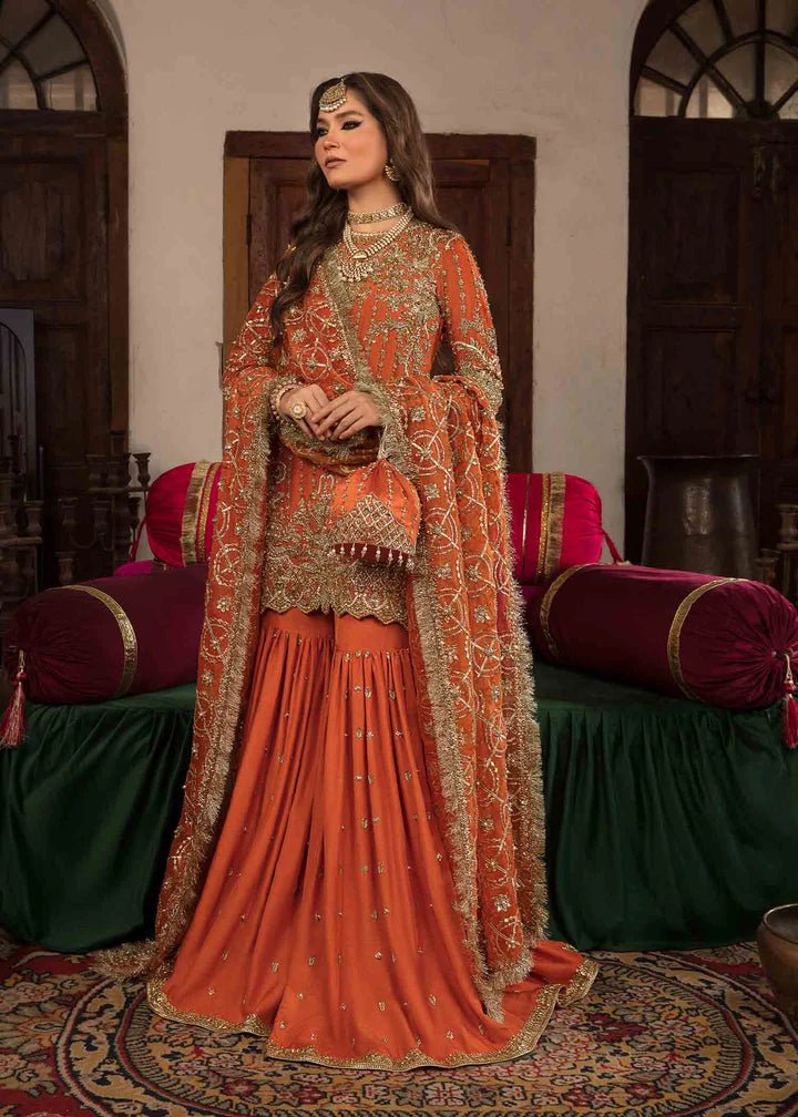 Model showcasing Kanwal Malik Angana '23 Narangi dress, representing Pakistani wedding attire online in the UK.