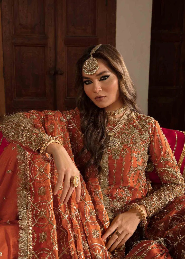 Model showcasing Kanwal Malik Angana '23 Narangi dress, representing Pakistani wedding attire online in the UK.