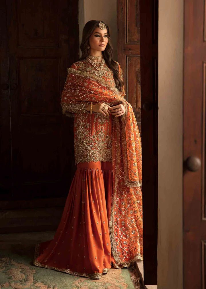 Model showcasing Kanwal Malik Angana '23 Narangi dress, representing Pakistani wedding attire online in the UK.