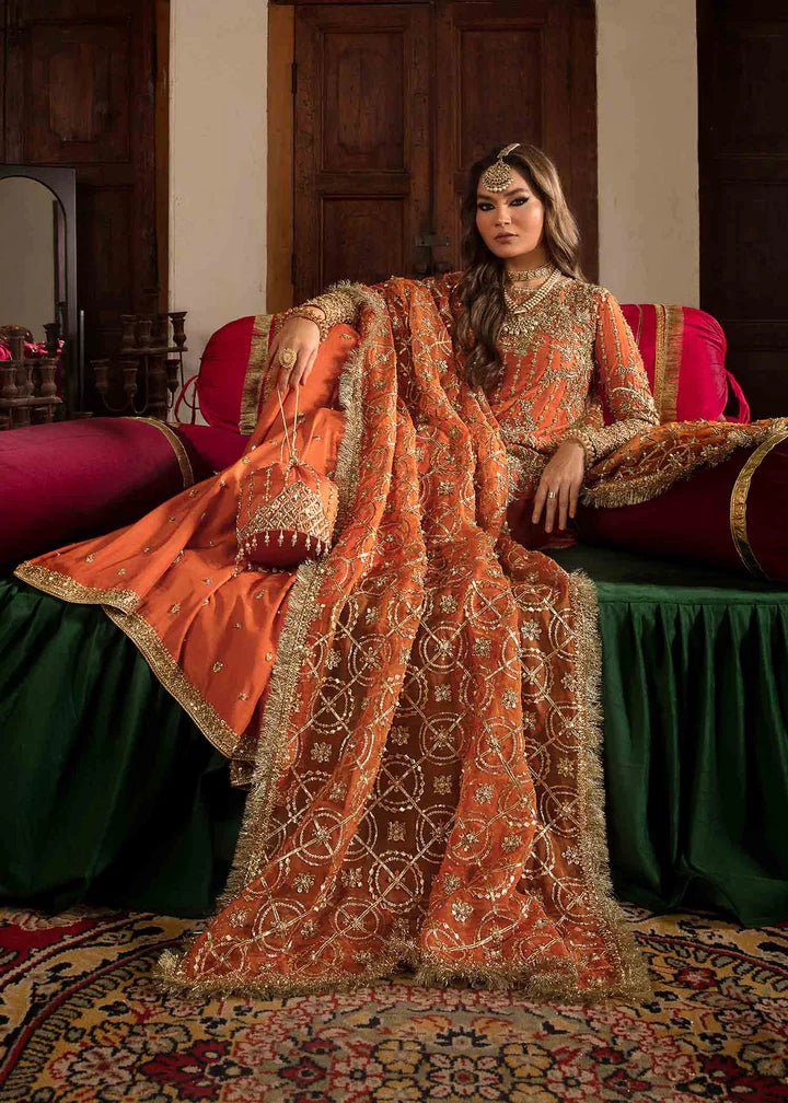 Model showcasing Kanwal Malik Angana '23 Narangi dress, representing Pakistani wedding attire online in the UK.