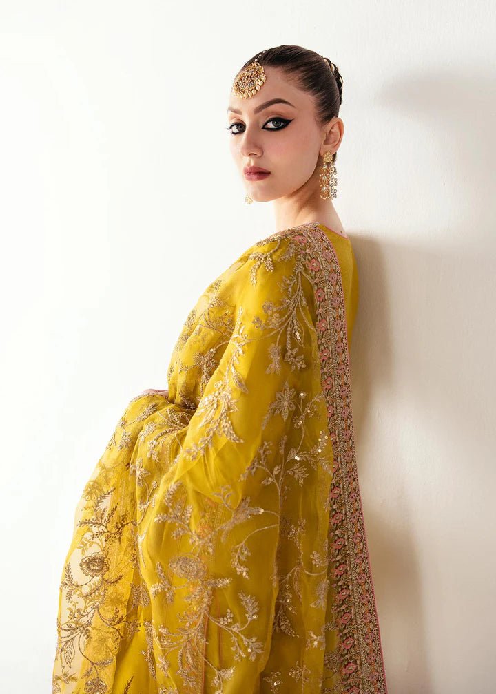 Model wearing a yellow Mahpara dress from Kanwal Malik's Jugan Luxury Pret 2024 collection. Pakistani designer clothes available online in the UK, perfect for weddings.