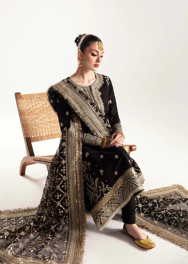 Model wearing a black Raha dress from Kanwal Malik's Jugan Luxury Pret 2024 collection. Pakistani designer clothes available online in the UK, perfect for weddings.