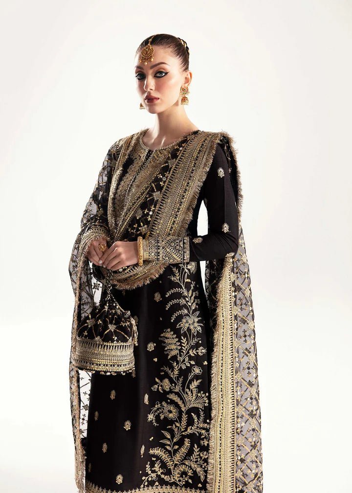 Model wearing a black Raha dress from Kanwal Malik's Jugan Luxury Pret 2024 collection. Pakistani designer clothes available online in the UK, perfect for weddings.