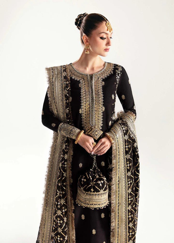 Model wearing a black Raha dress from Kanwal Malik's Jugan Luxury Pret 2024 collection. Pakistani designer clothes available online in the UK, perfect for weddings.