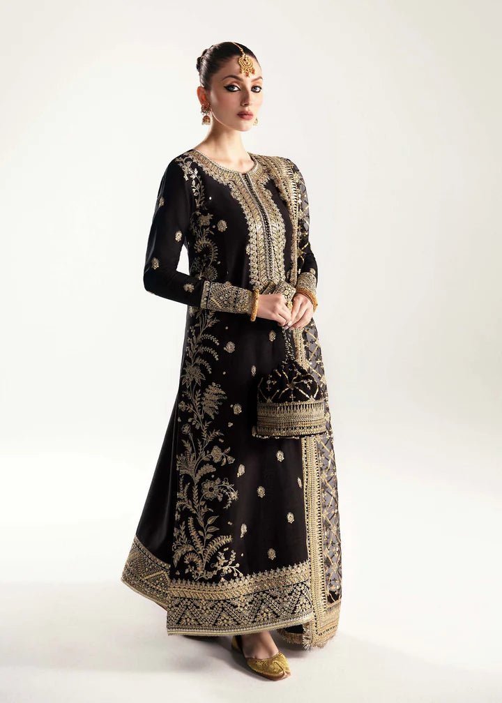 Model wearing a black Raha dress from Kanwal Malik's Jugan Luxury Pret 2024 collection. Pakistani designer clothes available online in the UK, perfect for weddings.