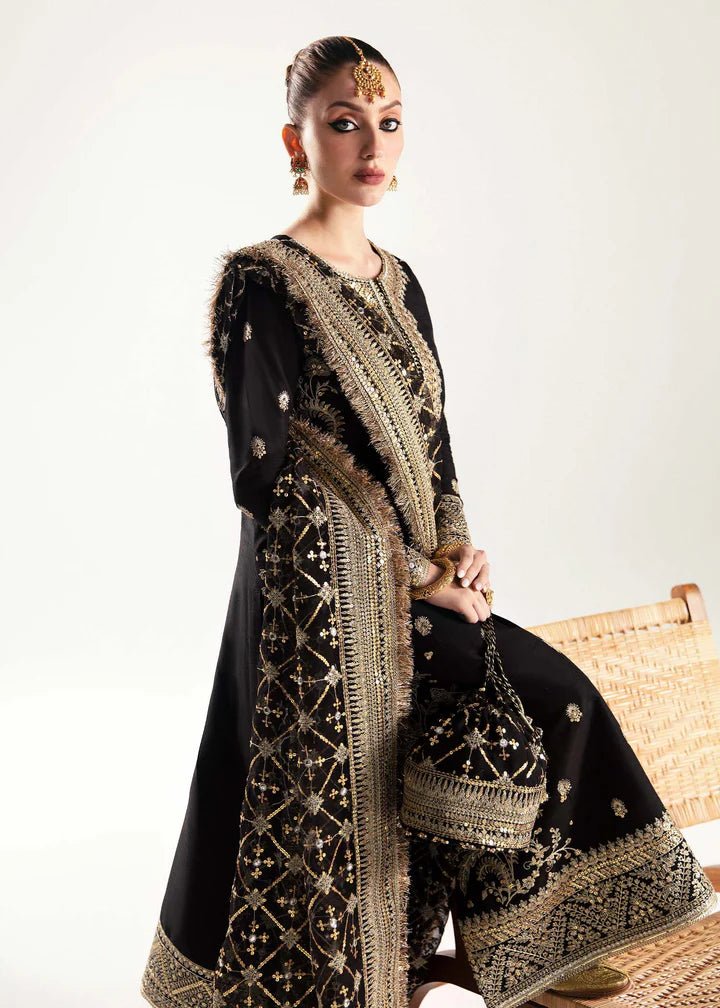 Model wearing a black Raha dress from Kanwal Malik's Jugan Luxury Pret 2024 collection. Pakistani designer clothes available online in the UK, perfect for weddings.