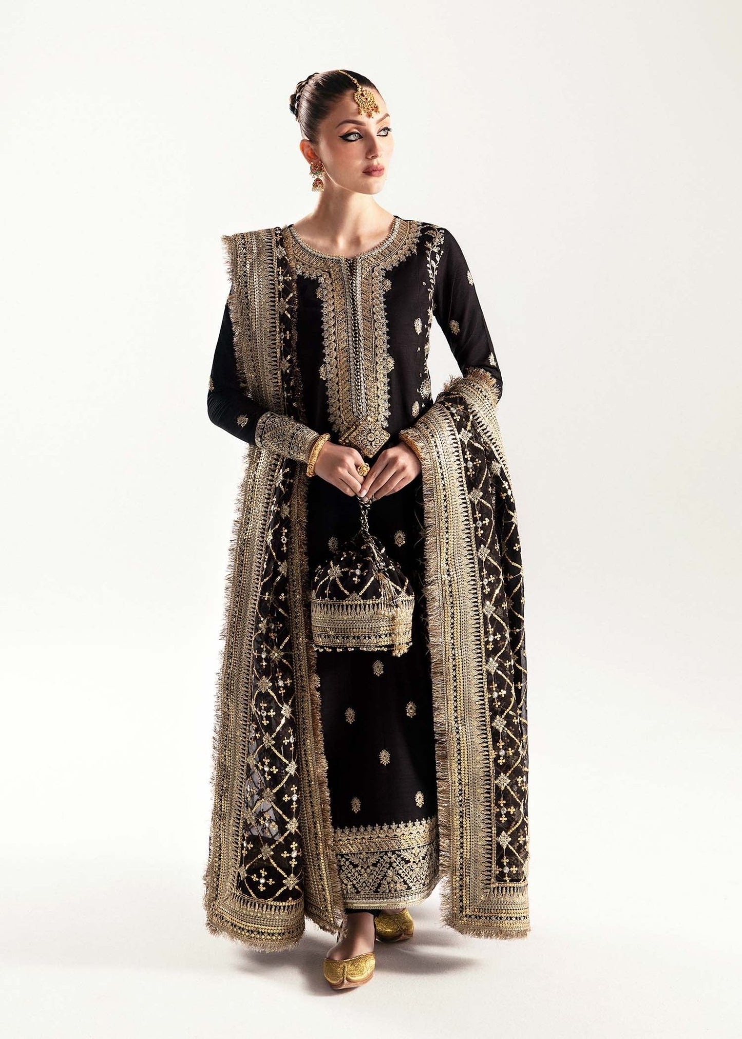 Model wearing a black Raha dress from Kanwal Malik's Jugan Luxury Pret 2024 collection. Pakistani designer clothes available online in the UK, perfect for weddings.