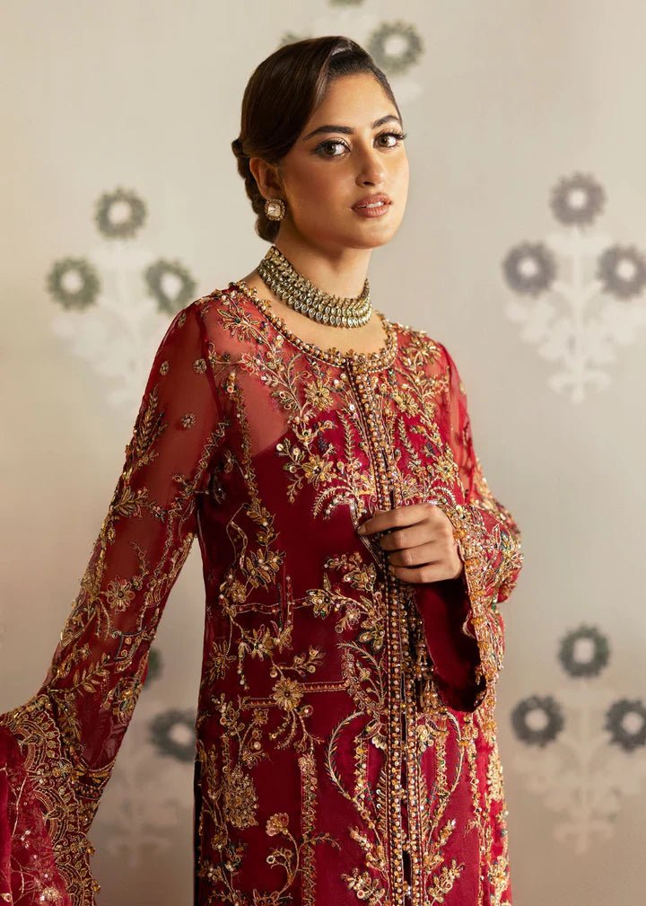 Model wearing Kanwal Malik Maahi Wedding Festive '24 ARMALA, a deep red ensemble with intricate gold embroidery, ideal for wedding celebrations. Available for Pakistani clothes online in the UK.