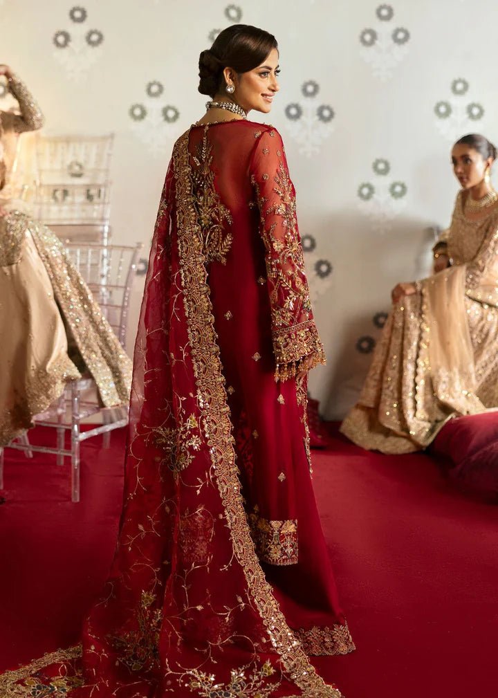 Model wearing Kanwal Malik Maahi Wedding Festive '24 ARMALA, a deep red ensemble with intricate gold embroidery, ideal for wedding celebrations. Available for Pakistani clothes online in the UK.