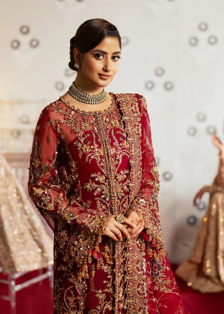 Model wearing Kanwal Malik Maahi Wedding Festive '24 ARMALA, a deep red ensemble with intricate gold embroidery, ideal for wedding celebrations. Available for Pakistani clothes online in the UK.