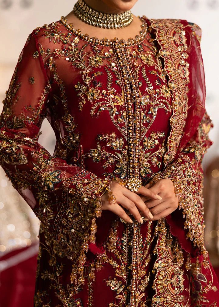 Model wearing Kanwal Malik Maahi Wedding Festive '24 ARMALA, a deep red ensemble with intricate gold embroidery, ideal for wedding celebrations. Available for Pakistani clothes online in the UK.