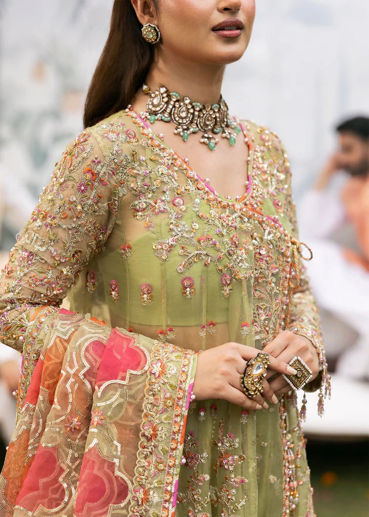 Model wearing Kanwal Malik Maahi Wedding Festive '24 AYAT, a stunning green ensemble with vibrant floral embroidery and an ornate dupatta, perfect for weddings. Available for Pakistani clothes online in the UK.