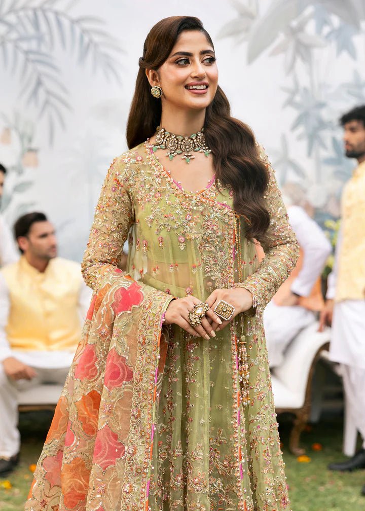 Model wearing Kanwal Malik Maahi Wedding Festive '24 AYAT, a stunning green ensemble with vibrant floral embroidery and an ornate dupatta, perfect for weddings. Available for Pakistani clothes online in the UK.