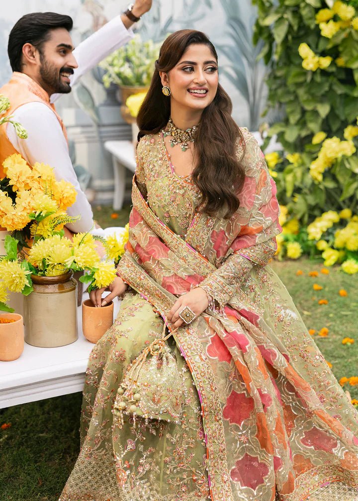 Model wearing Kanwal Malik Maahi Wedding Festive '24 AYAT, a stunning green ensemble with vibrant floral embroidery and an ornate dupatta, perfect for weddings. Available for Pakistani clothes online in the UK.