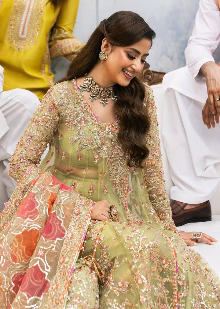 Model wearing Kanwal Malik Maahi Wedding Festive '24 AYAT, a stunning green ensemble with vibrant floral embroidery and an ornate dupatta, perfect for weddings. Available for Pakistani clothes online in the UK.